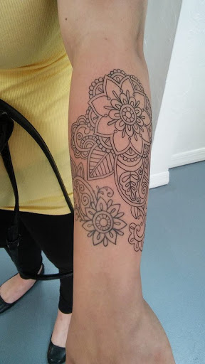 Explore rose tattoo ideas for women, creative tattoo ideas in Fort Myers, available at Tiger Lotus Tattoo and Piercing