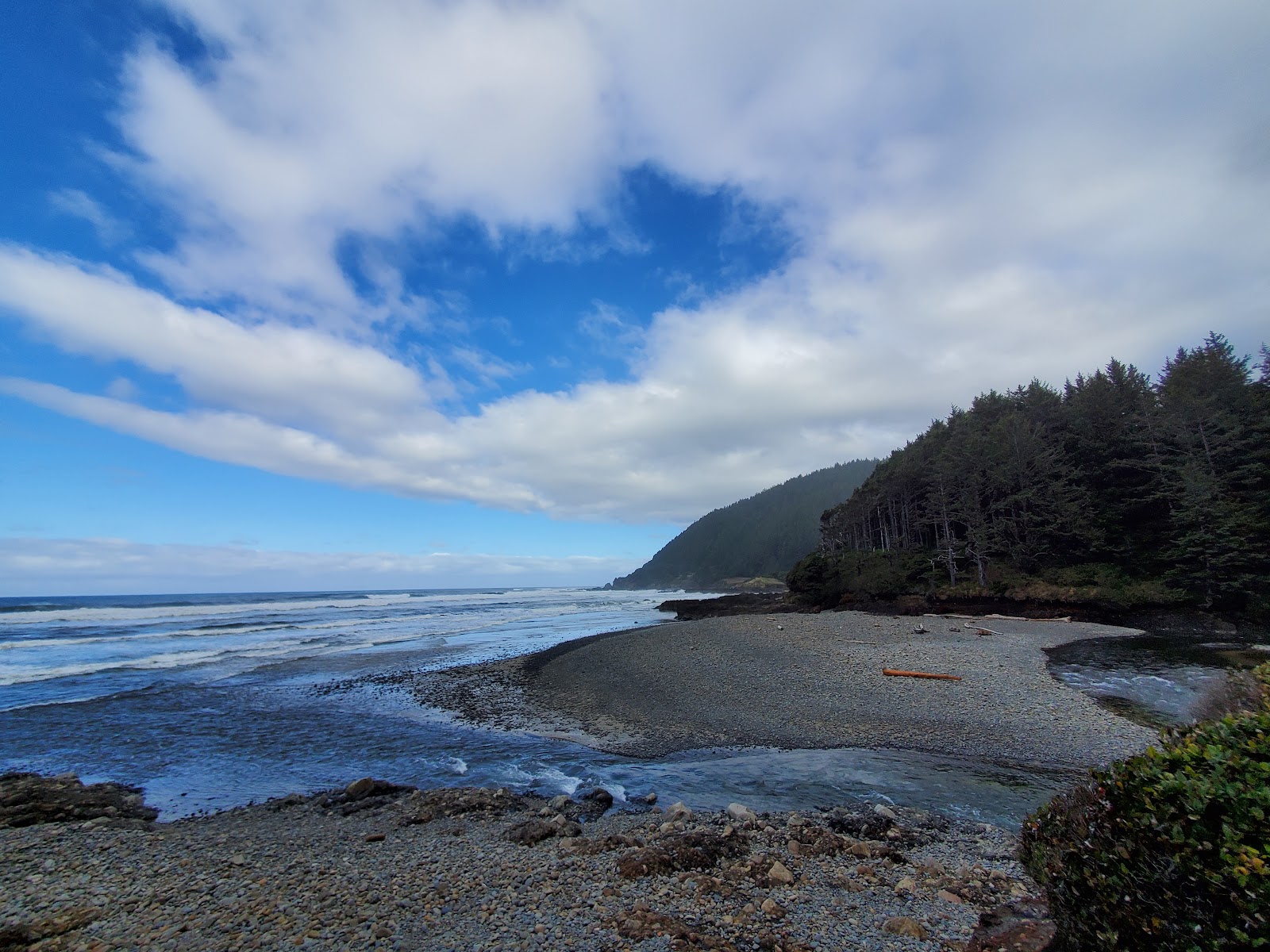 Foto af Neptune Beach bakket op af klipperne