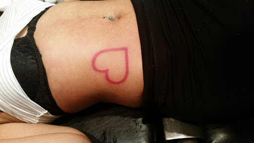 Find in between boob tattoo ideas for your next unique tattoo in Erie at EliKingInk