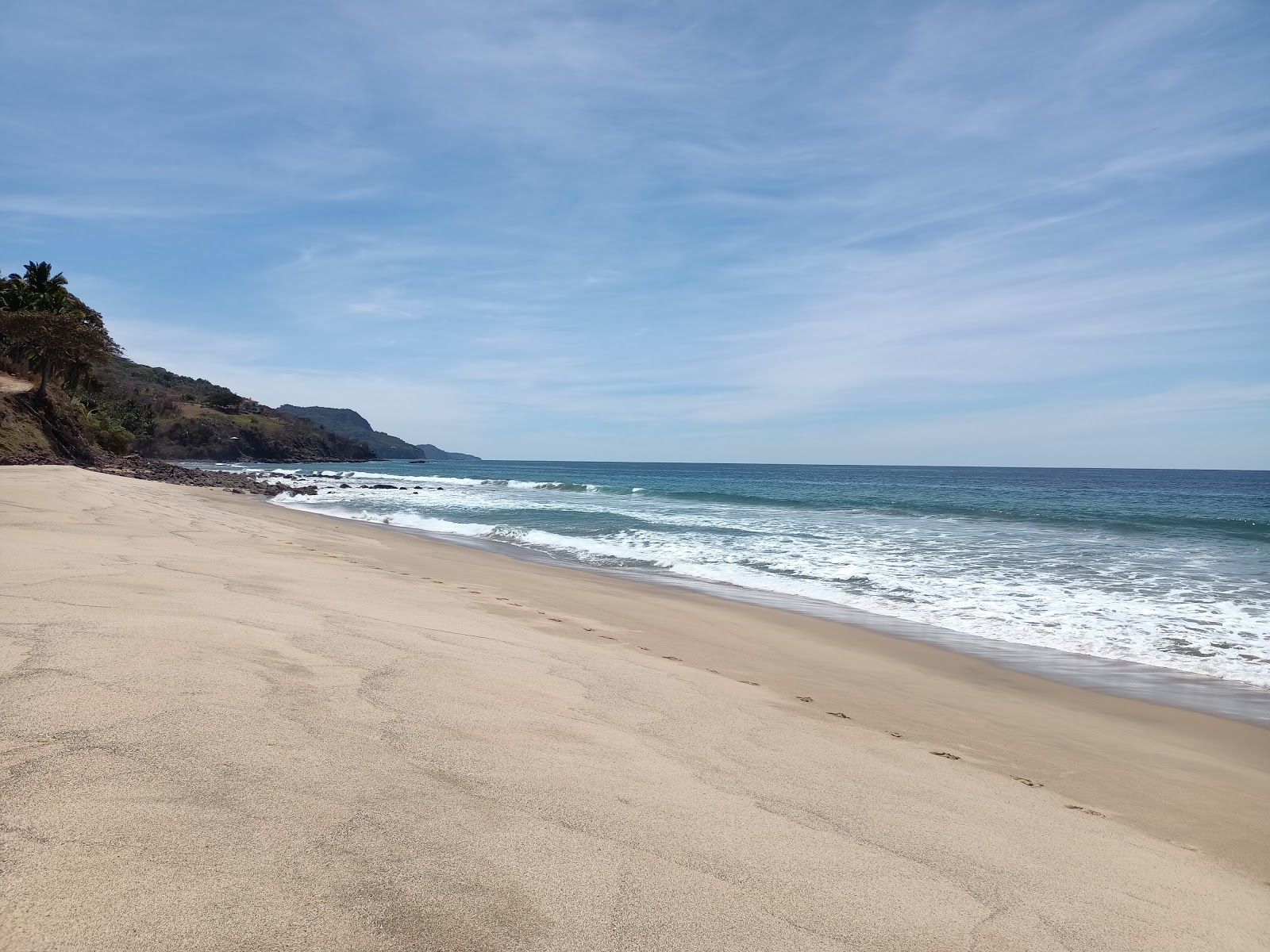 Foto van Punta Raza beach met helder fijn zand oppervlakte