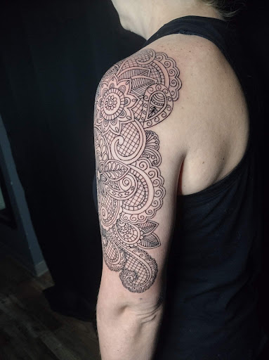 Find rib tattoo ideas for females for your next unique tattoo in Oelwein at Purple Thistle Tattoo