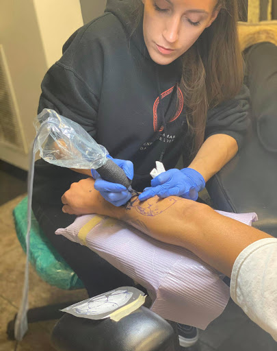 Explore women's hand tattoo ideas, creative tattoo ideas in Fort Wayne, available at Grade A Tattoos and Body Piercing