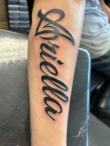Explore name cover up tattoo ideas for men, creative tattoo ideas in Des Moines, available at Adrenaline Studios Tattoo