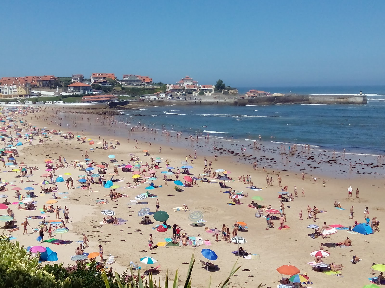 Photo of Comillas Beach backed by cliffs