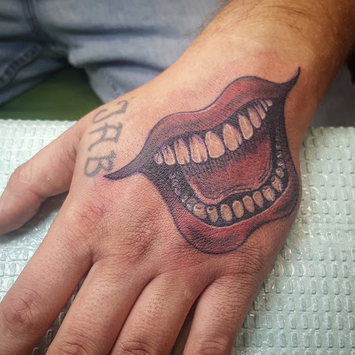 Explore guy hand tattoo ideas, creative tattoo ideas in Three Rivers, available at Portfolio Ink, LLC