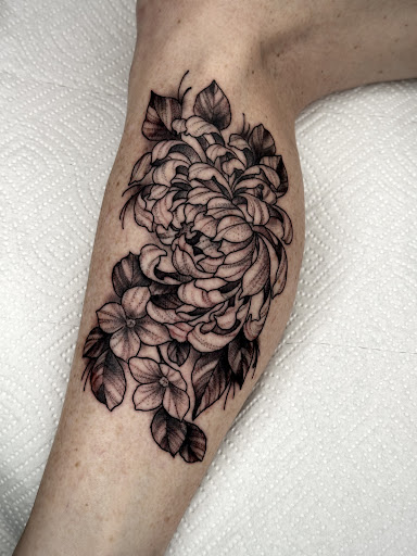 Explore cool thigh tattoo ideas, creative tattoo ideas in Lakeview, available at Backwoods Tattoo Studio