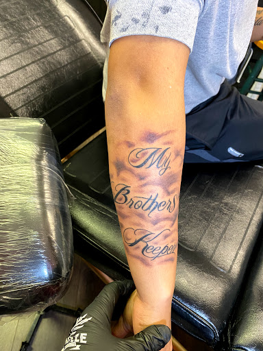 Explore ribbon tattoo ideas, creative tattoo ideas in Corinth, available at Village Ink Therapy Tattoos