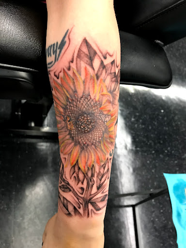 Explore tricep tattoo ideas for men, creative tattoo ideas in Lincoln, available at Edison Tattoo and Body Piercing