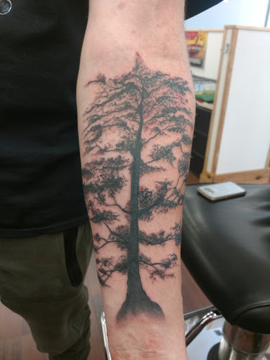 Explore negative space tattoo ideas, creative tattoo ideas in Cedar Springs, available at Americas Renegade Tattoo Society