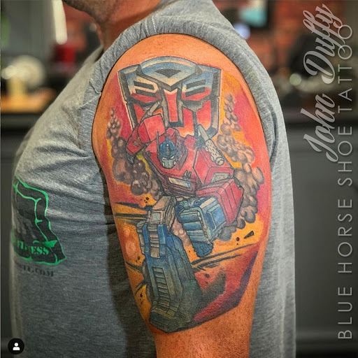 Explore dandelion tattoo ideas, creative tattoo ideas in Portsmouth, available at World Famous Blue Horseshoe Tattoo and Piercing