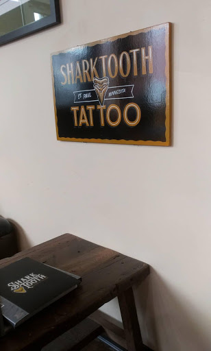 Explore bourbon glass tattoo idea, creative tattoo ideas in Lakeville, available at SharkTooth Tattoo & Gallery