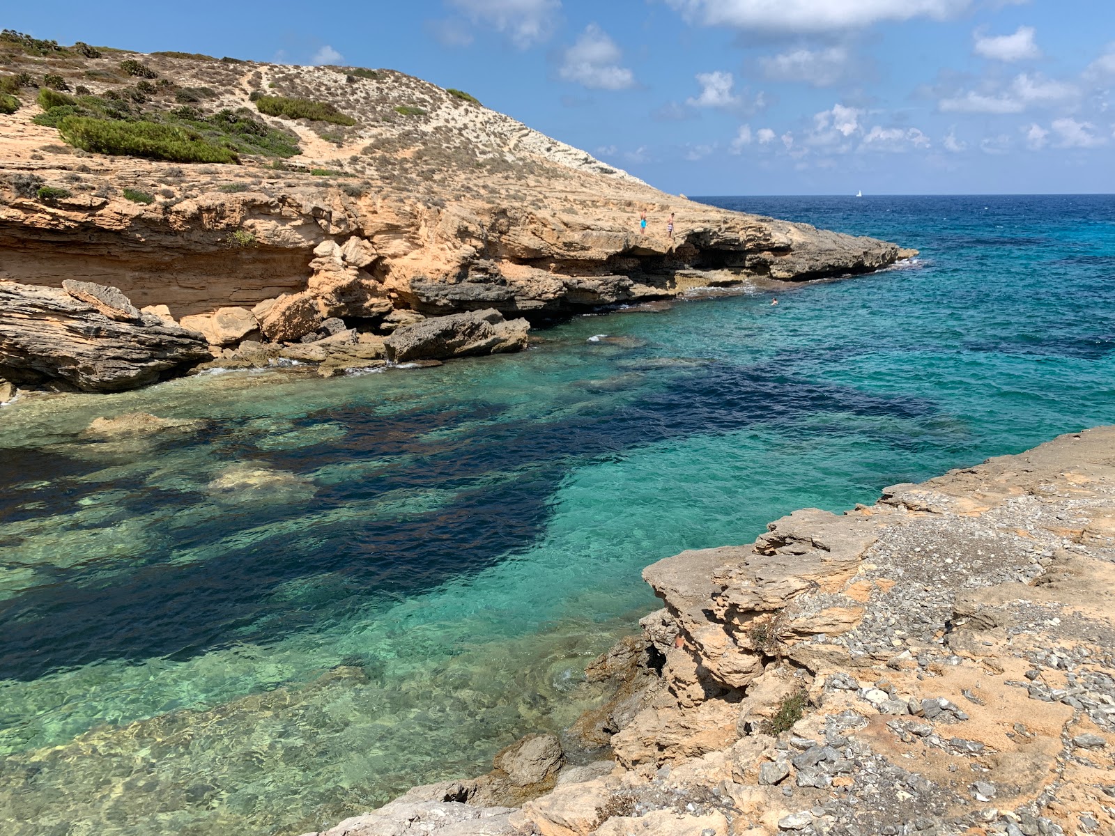 Photo of Cala Estreta with turquoise pure water surface