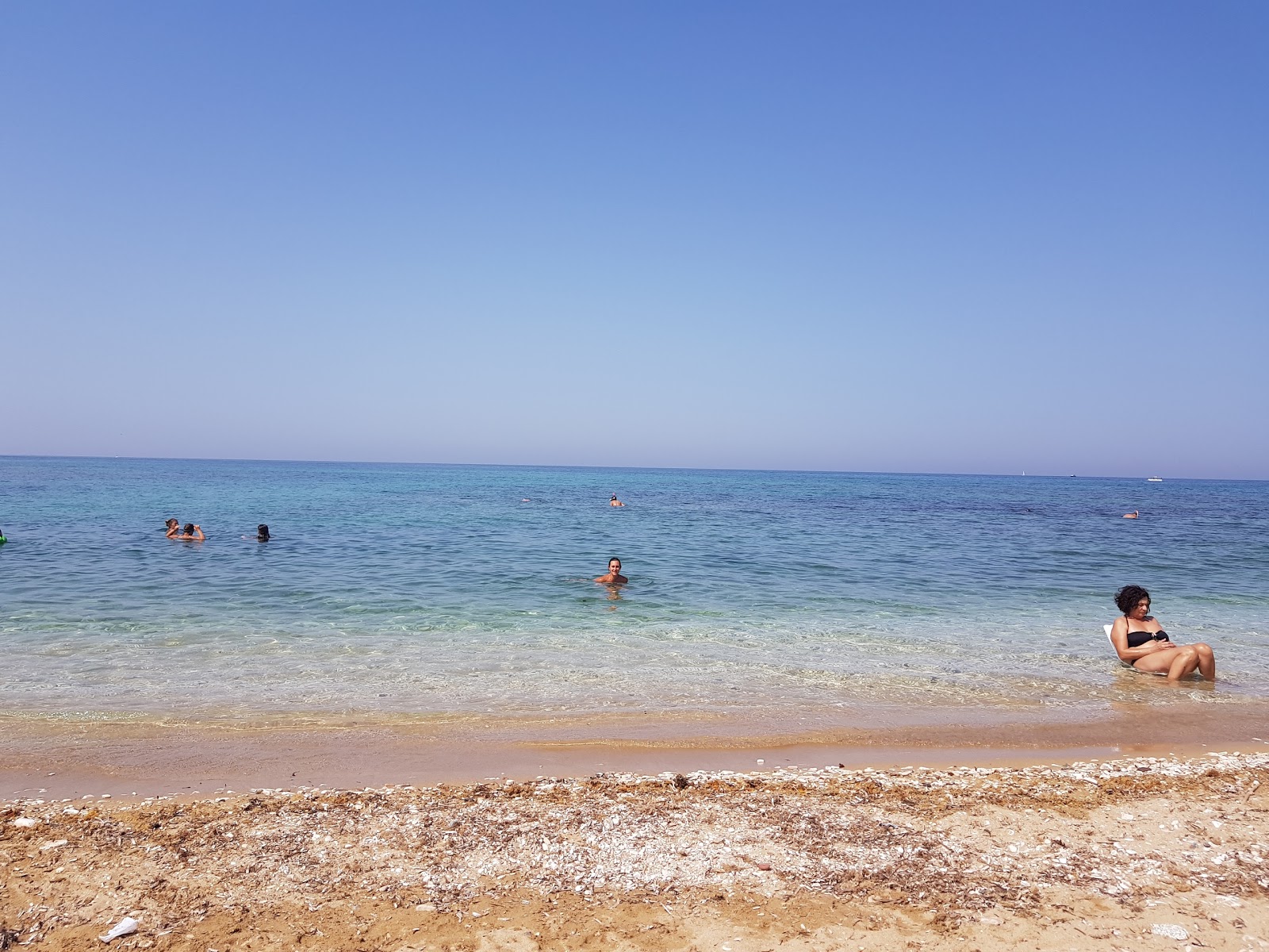 Photo of La Fonte beach with blue pure water surface