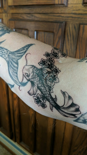 Explore hand tattoo idea, creative tattoo ideas in Lakeville, available at SharkTooth Tattoo & Gallery