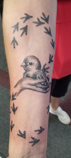 Explore under breast tattoo ideas for females, creative tattoo ideas in Prudenville, available at Dark Horse Tattoo Studio