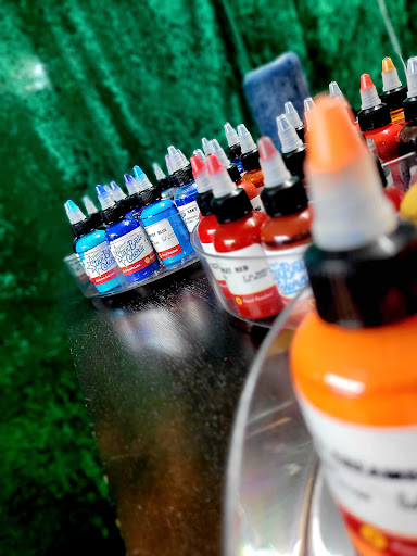 Explore woman leg tattoo ideas, creative tattoo ideas in Benton, available at Spectrum Tattoo