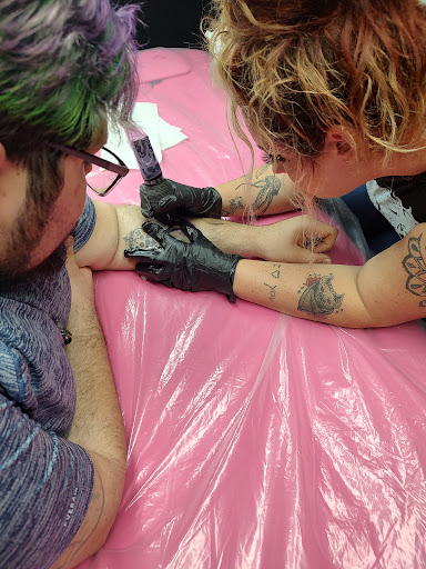 Explore koi fish sleeve tattoo ideas, creative tattoo ideas in Lake City, available at Crooked Spines Tattoo Studio