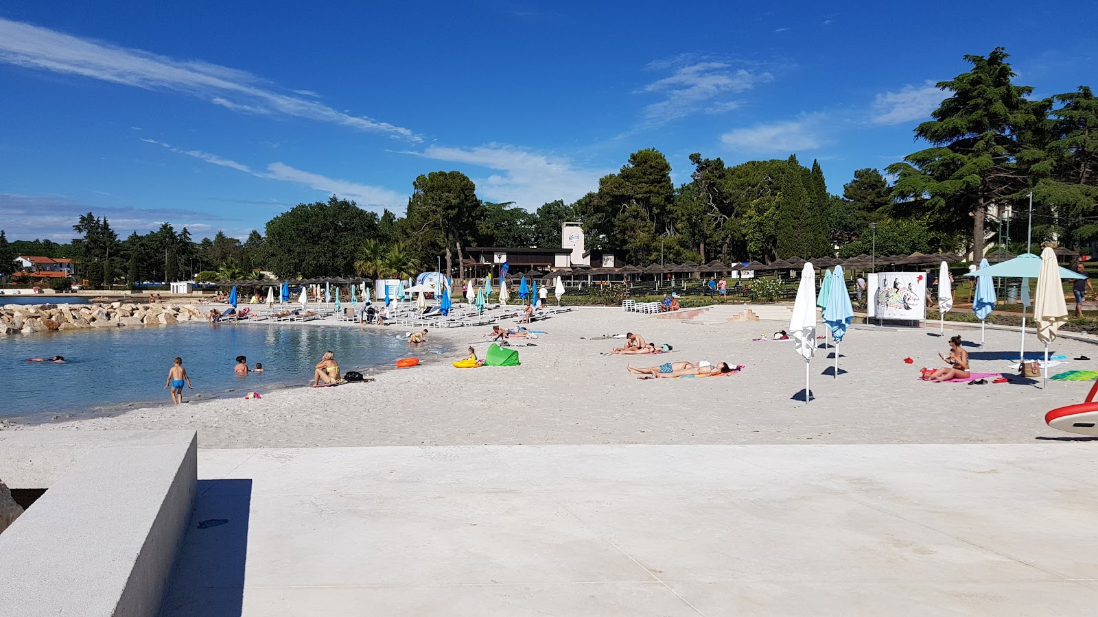 Photo of Porec beach with turquoise pure water surface