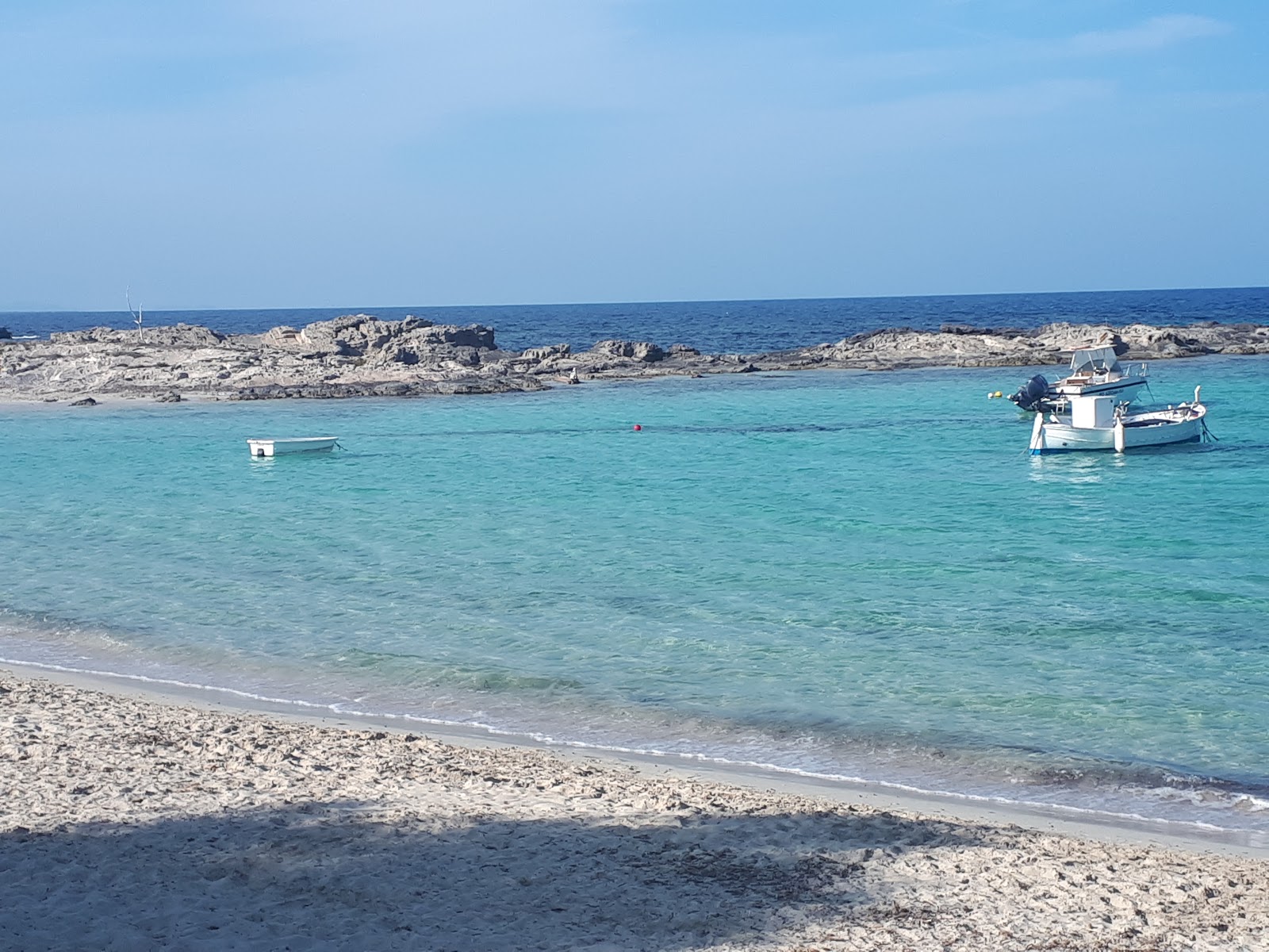Photo of Platja Es Pujols with turquoise pure water surface