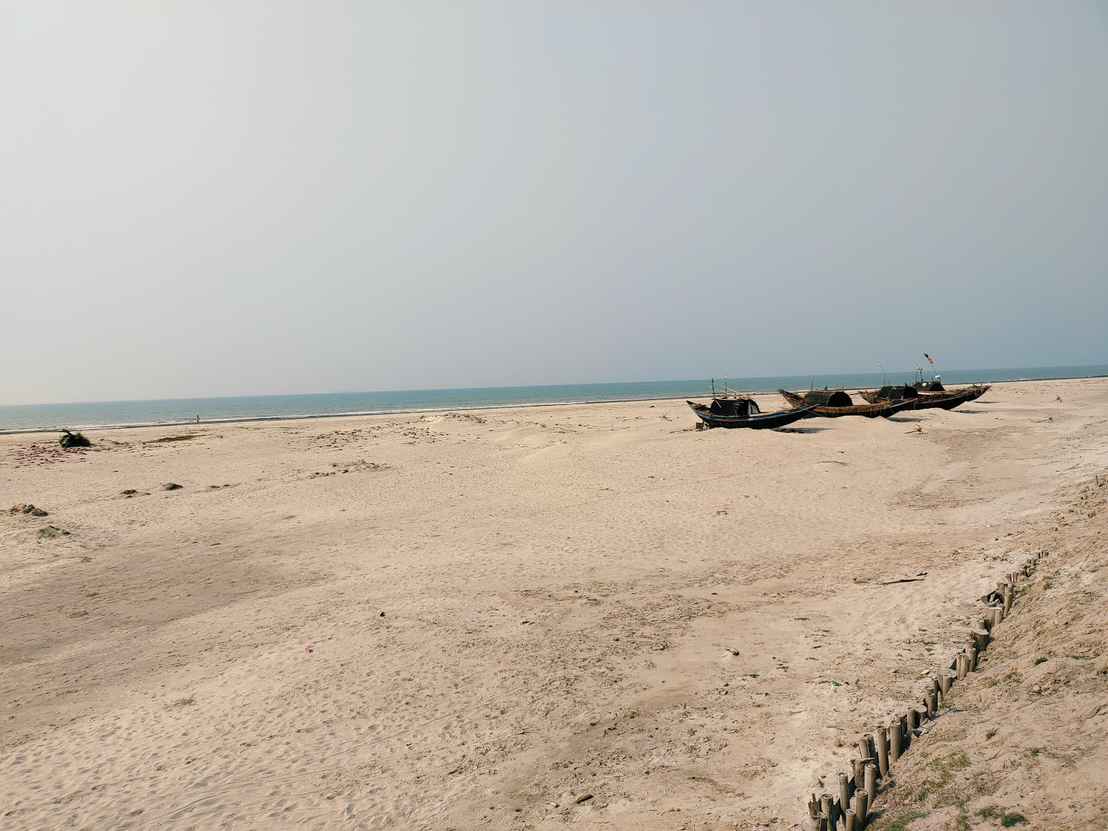 Valokuva Dhabalat Beachista. pinnalla kirkas hiekka:n kanssa
