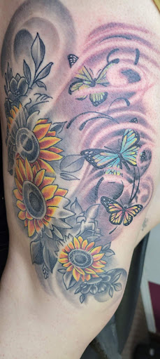 Explore swirl tattoo ideas, creative tattoo ideas in Angola, available at Hoodlum Ink