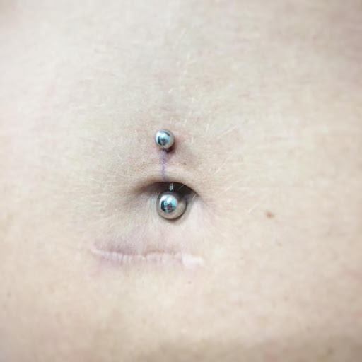 Explore snoopy tattoo ideas, creative tattoo ideas in Louisburg, available at Purple Dot Piercings