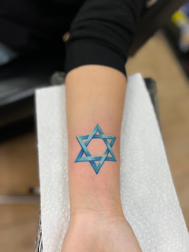 Explore february birth flower tattoo ideas, creative tattoo ideas in Astoria, available at Xolotl Tattoo Gallery