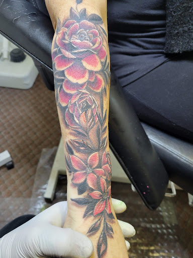 Explore red tattoo cover up ideas, creative tattoo ideas in Angola, available at Hoodlum Ink