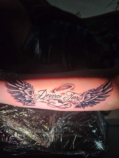 Explore trash polka tattoo ideas, creative tattoo ideas in Angola, available at Hoodlum Ink