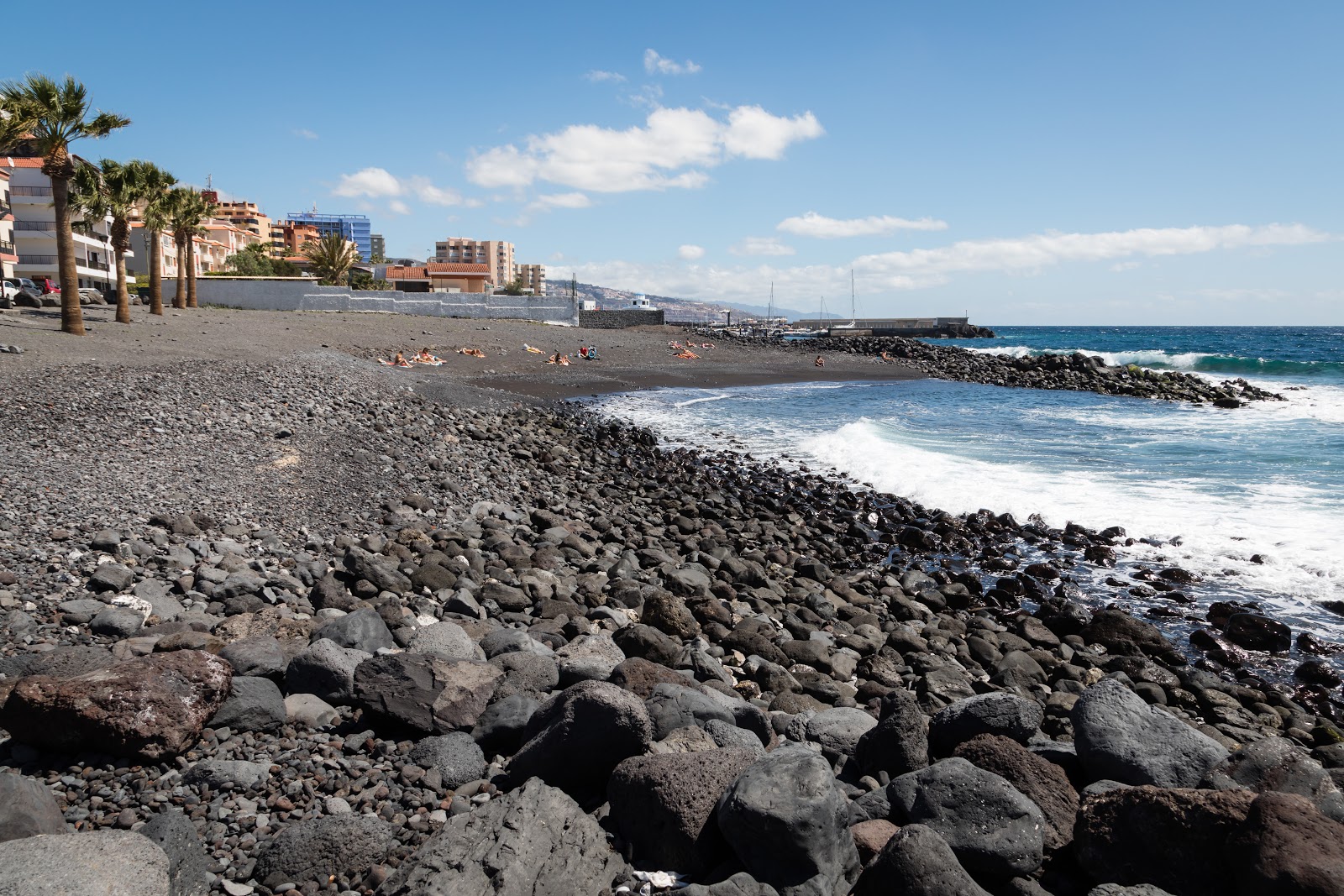 Photo of Playa de Olegario with gray sand &  rocks surface