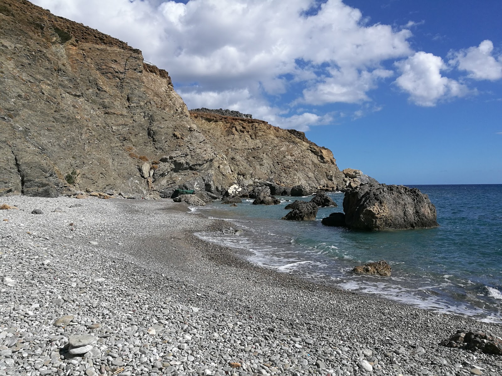 Photo of Hiromili beach with turquoise pure water surface