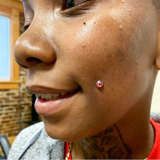 Find small tattoo between breast ideas for your next unique tattoo in Summerville at Exotic Impressions Body Piercing