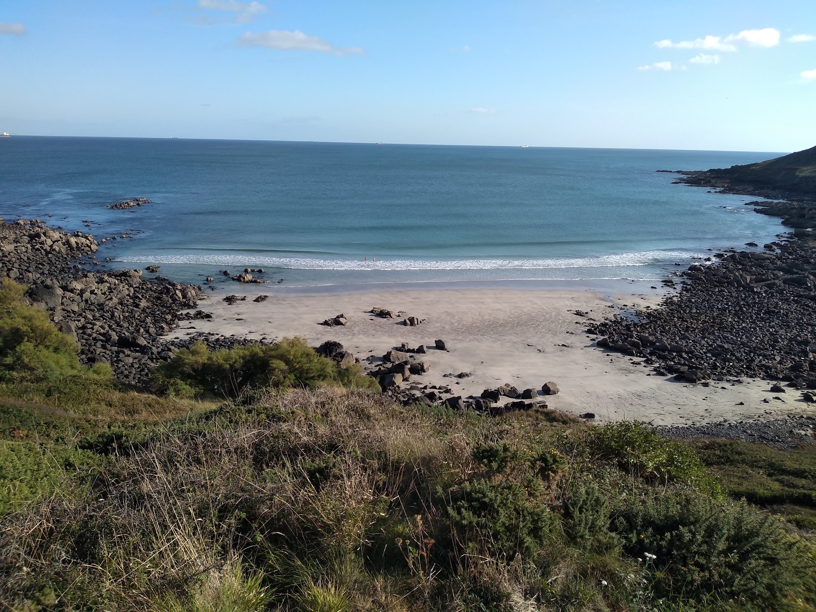 Photo of Porthbeer Cove with turquoise pure water surface