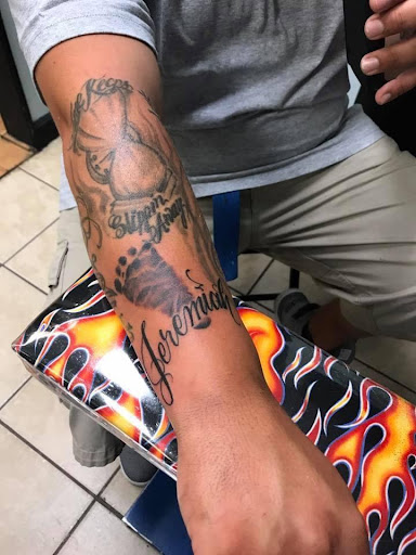 Explore ribbon tattoo ideas, creative tattoo ideas in Goose Creek, available at Red Kirin Tattoo