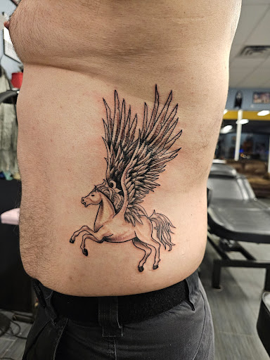 Explore tattoo ideas for lower abdomen, creative tattoo ideas in Palm Harbor, available at Angry Owl Tattoo and Piercing