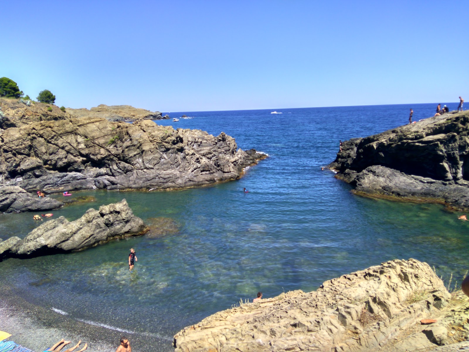 Photo of Cala Bramant with blue pure water surface