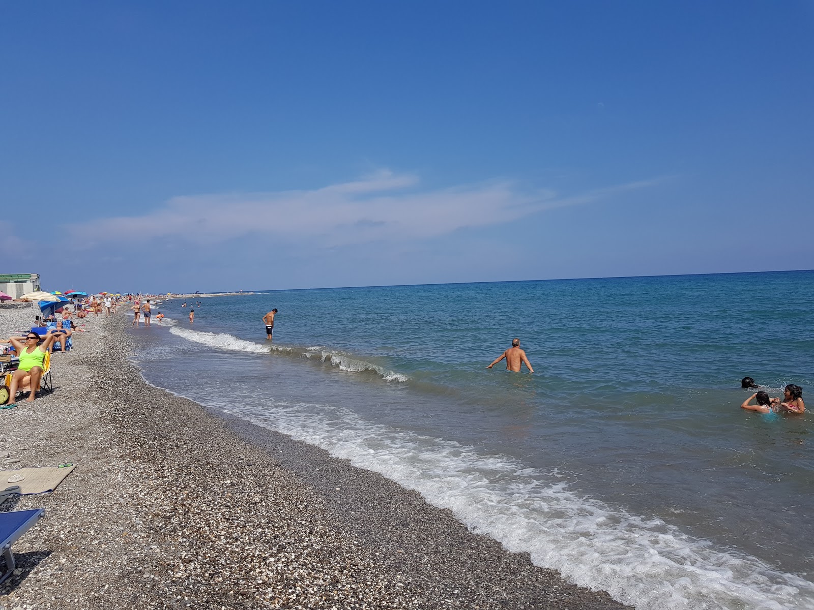 Foto di Capo Lena beach con una superficie del sabbia con ciottolame