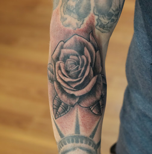 Find tattoo ideas between breast for your next unique tattoo in Sevierville at Hudsons House Of Ink
