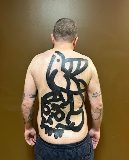 Explore medium tattoo ideas for men, creative tattoo ideas in Albany, available at Dead Presidents Lounge