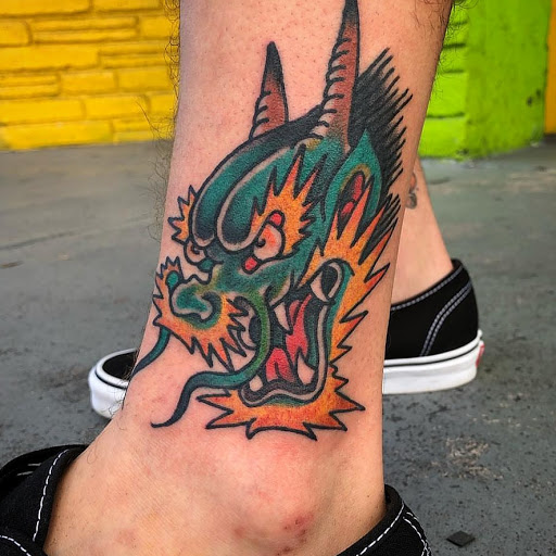 Explore rose thigh tattoo ideas, creative tattoo ideas in Miami, available at Green Machine Tattoos & Body Piercing