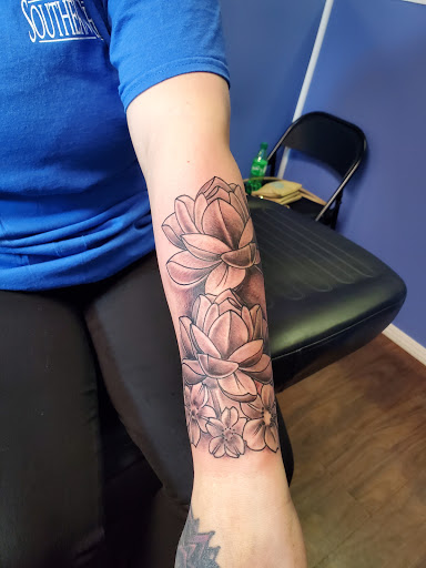 Explore flower tattoo ideas on arm, creative tattoo ideas in Tupelo, available at Primal Ink Tattoo Studio