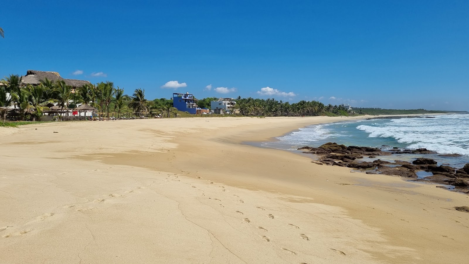 Foto di Playa Agua Blanca con una superficie del sabbia beige fine