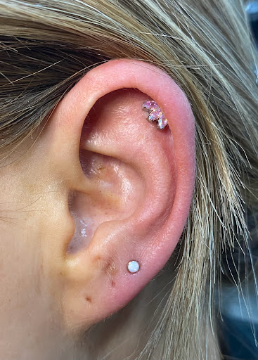 Explore leg tattoo ideas for men, creative tattoo ideas in Orange, available at Symbiosis Body Piercing