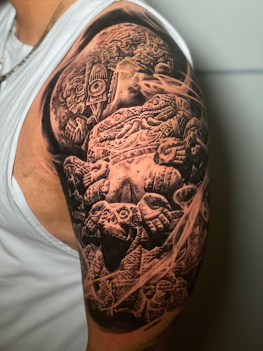 Explore mens back shoulder tattoo ideas, creative tattoo ideas in Seattle, available at Art Never Dies Tattoo and Gallery