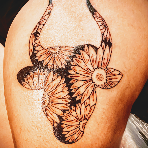 Explore skull neck tattoo ideas, creative tattoo ideas in Denison, available at Crossroads Tattoo Studio