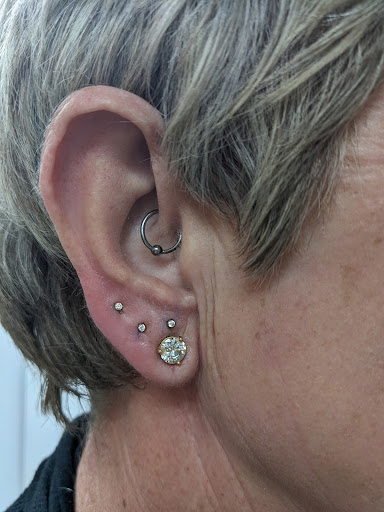 Explore back flower tattoo ideas, creative tattoo ideas in Saint George, available at Medusas Piercing Studio