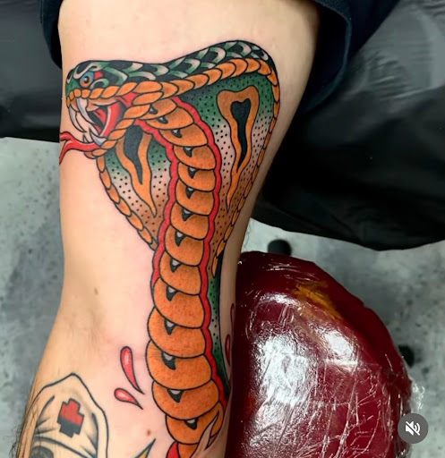 Explore female big tattoo ideas, creative tattoo ideas in Orange, available at Black Palm Tattoo