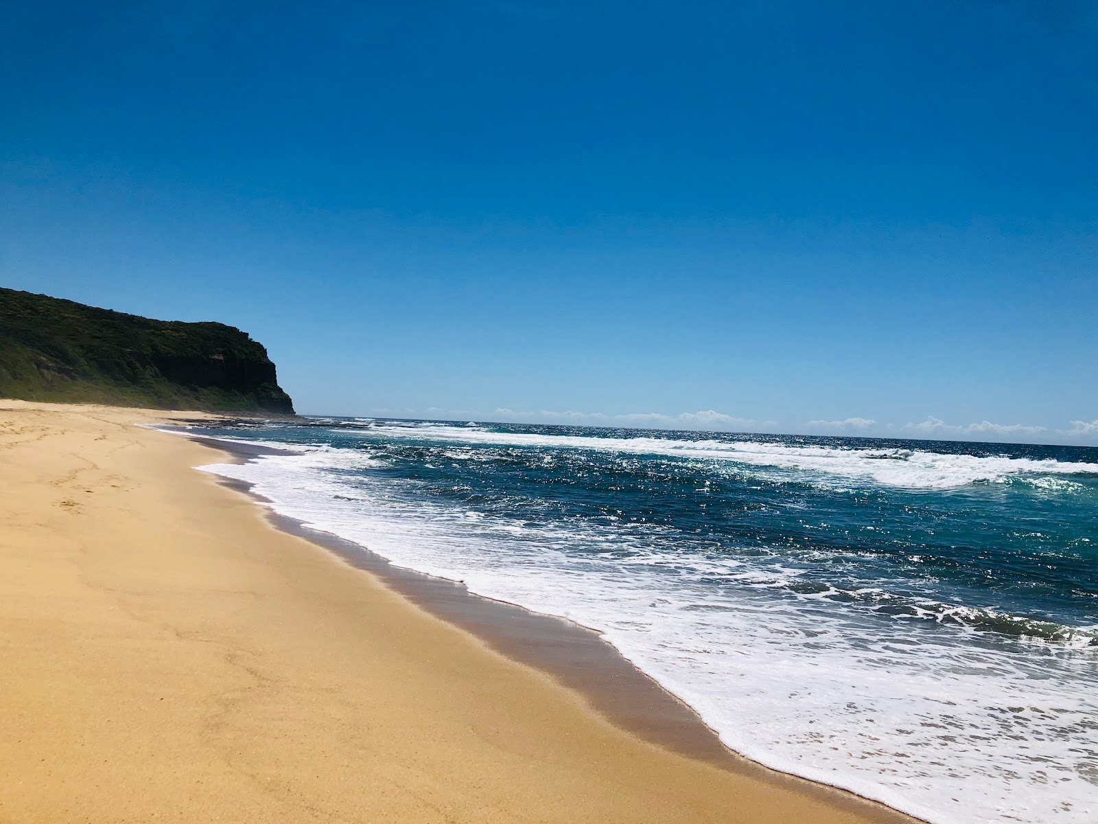 Foto av Dudley Beach med ljus sand yta