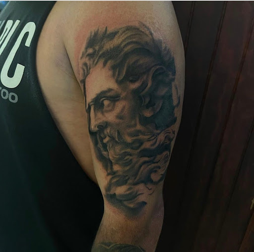 Explore black mens tattoo ideas, creative tattoo ideas in Clinton, available at Black Relic Tattoo