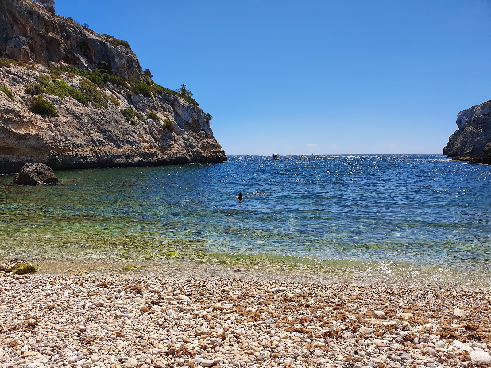 Foto av Cala Bota med lätt sten yta